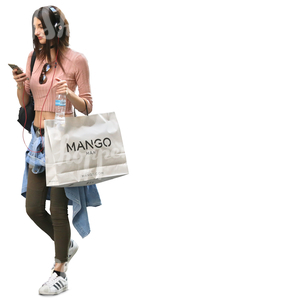 woman carrying a big shopping bag walking and listening to music