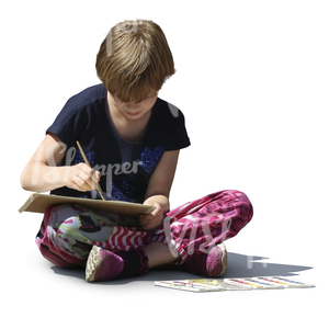 girl sitting on the ground and painting