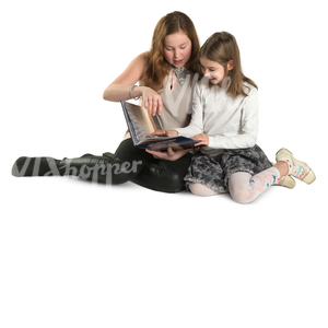 two girls sitting on the ground and reading a book