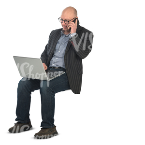man sitting with a laptop on his knees and working