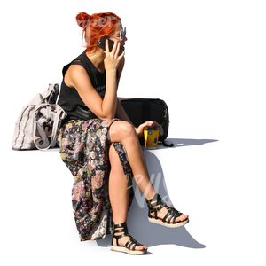 red haired woman sitting and talking on the phone