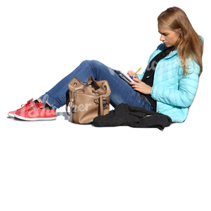 woman sitting on the ground and writing in her notebook