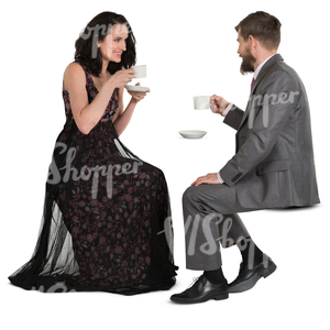 man and woman in fancy clothes sitting in a cafe