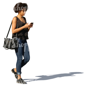 african woman walking and texting