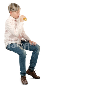 boy sitting in a cafe and drinking juice