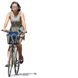 woman in a summer dress riding a bicycle