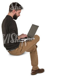 man sitting and working with a laptop