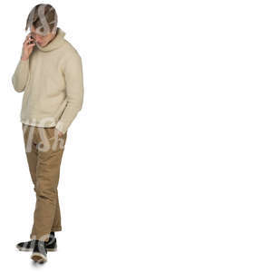 young man in a sweater walking and talking on the phone