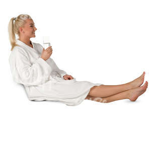 woman in a white bathrobe sitting in a spa