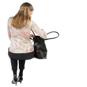 woman sitting and putting smth in her purse