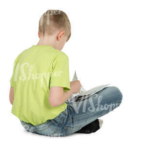 boy sitting on the floor and reading a book