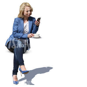 woman sitting in a street cafe and drinking coffee