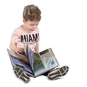 boy sitting on the floor with a book