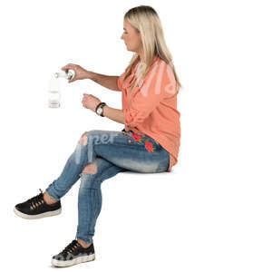 woman sitting in a cafe and pouring herself some water