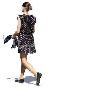 woman in a short summer dress walking in sunlight