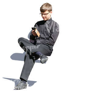 teenage boy sitting and texting