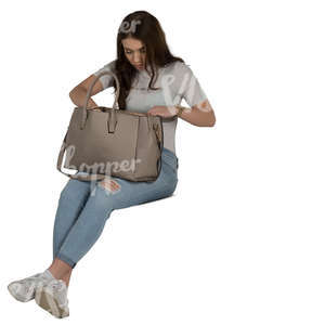 woman sitting and looking for smth from her bag