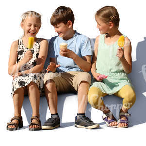 three children sitting and eating ice cream