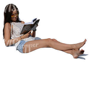 woman lying on lounge chair and reading a book