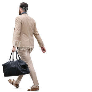 man in a beige suit carrying a bag