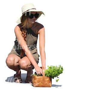 woman with a herbs basket squatting