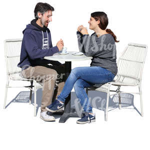 man and woman sitting in a cafe and drinking coffee