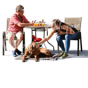 man and woman with a dog sitting in a cafe