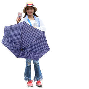 young woman with an umbrella standing and taking picture