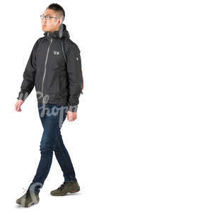 asian man in a hooded sports jacket walking 