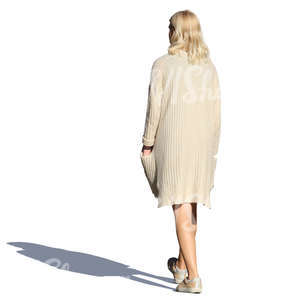 woman in a beige cardigan walking