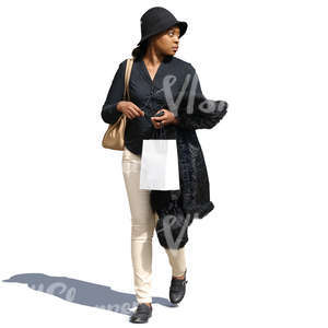 black woman walking with a shopping bag in hand