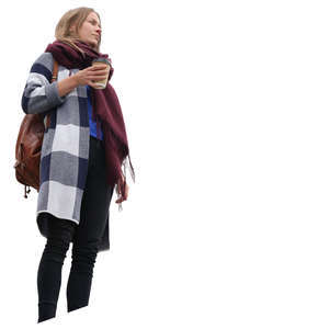 woman standing on a balcony and drinking coffee