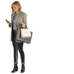 woman with shopping bags standing and texting