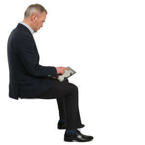 businessman sitting and checking his tablet