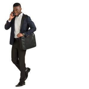 african businessman walking and talking on the phone