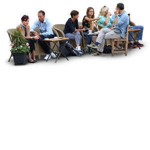 group of people sitting in a street cafe