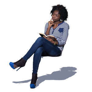 african woman sitting and reading a book