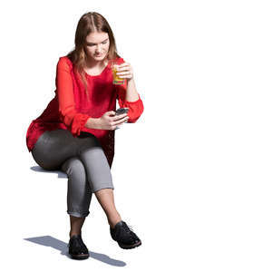 young woman sitting in a cafe and drinking juice