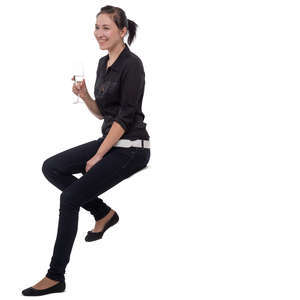 young woman sitting at a bar and drinking champagne