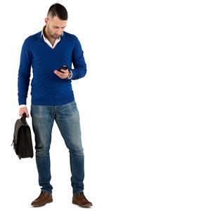 young man with a briefcase standing and texting 