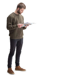 man standing and reading a magazine