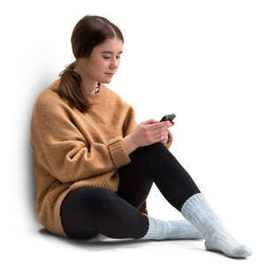 young woman in a sweater sitting and texting