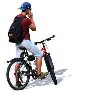 man with a bicycle standing and talking on the phone