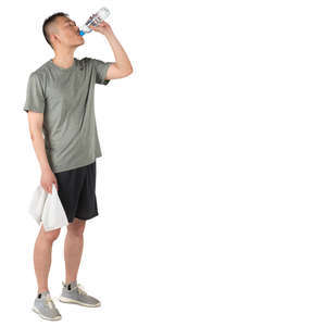 asian man in a gym standing and drinking water