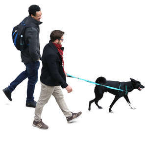 two men walking with a dog seen from above
