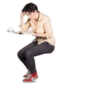 woman sitting in a cafe and reading a book