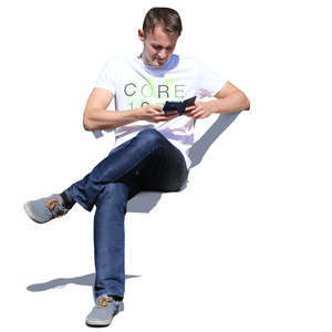 man sitting and checking his phone