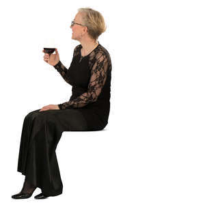woman in a formal black dress sitting and drinking wine