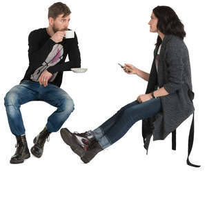 man and woman sitting in a cafe and drinking coffee