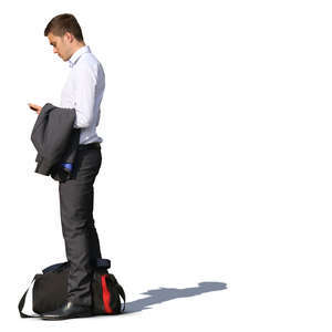 man in a suit standing and looking at his phone